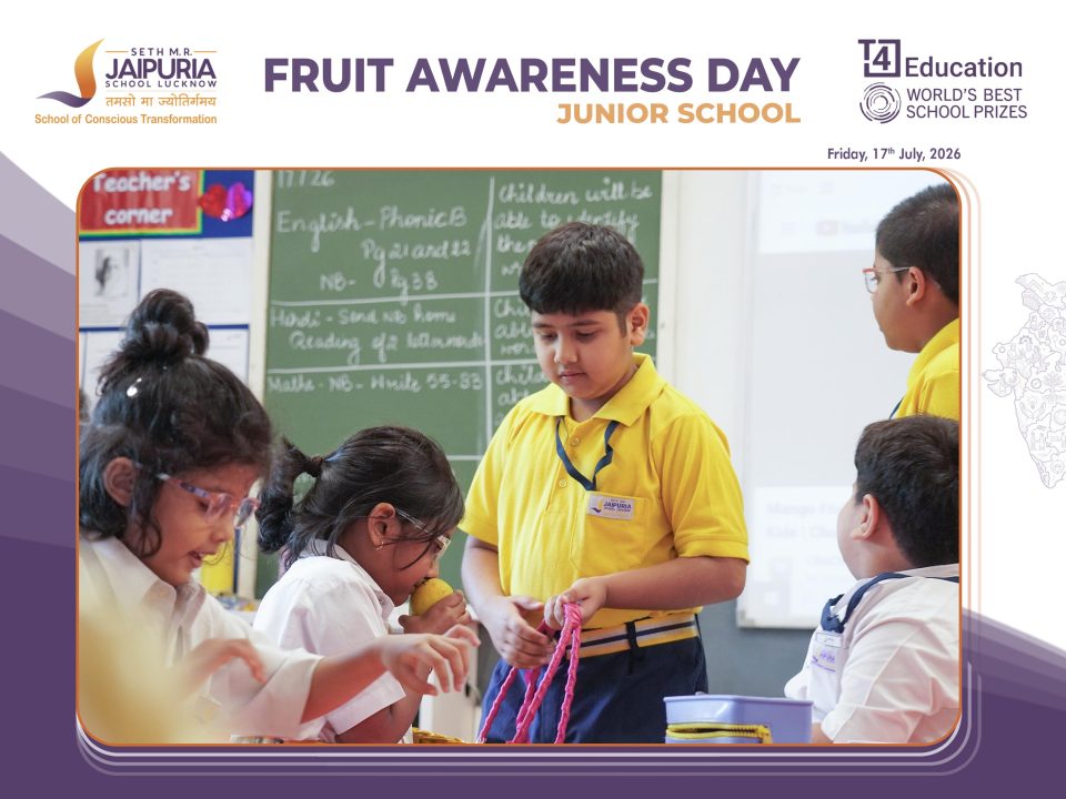 Students in yellow uniforms work together on fruit-themed crafts during Fruit Awareness Day in a classroom setting.