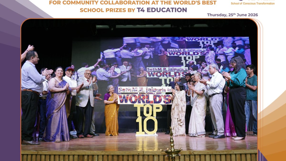 Group of people in formal attire on a stage during an award ceremony, with a large 'WORLD'S TOP 10' display in the background.