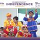 Children in bright traditional outfits performing a dance at a school Independence Day event.