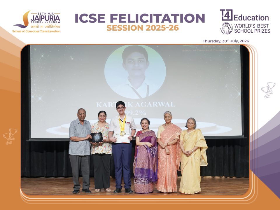 Group of students and seniors on a stage during an ICSE Felicitation ceremony, posing with medals and certificates.