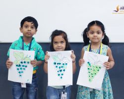 Students with their green grape artwork