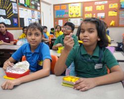 Students having mangoes in their fruit tiffin