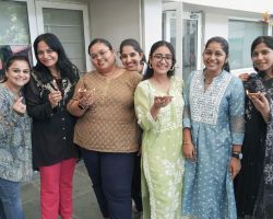 A group of teachers posing with diyas
