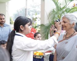 A student welcoming one of the guests.