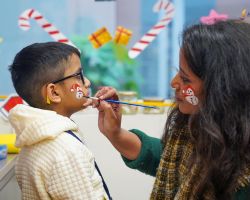 Painted with joy, hands and faces glowing with the Christmas spirit.