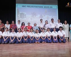 Group photo of students in uniform with teachers on stage during ISC Felicitation 2025-26 at Jaipuria School Lucknow.